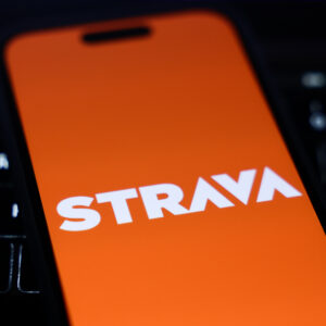 A laptop keyboard and Strava logo displayed on a phone screen are seen in this illustration photo taken in Krakow, Poland on January 15, 2025. (Photo by Jakub Porzycki/NurPhoto via Getty Images)