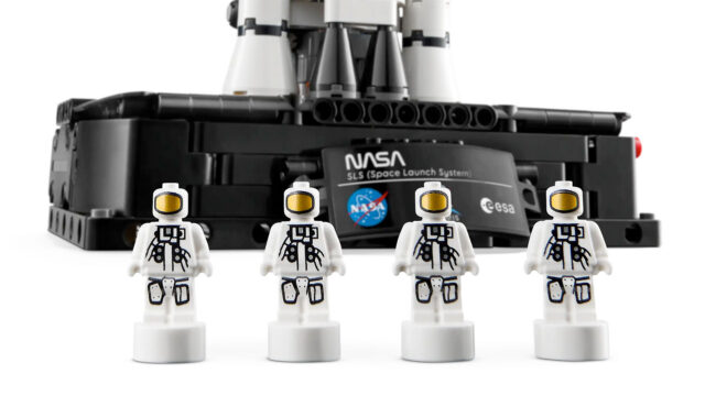Illustration of four small astronaut figures as part of a toy construction model rocket set.