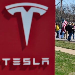 Protesters gather at the Tesla dealership in Chesterfield, Mo., on March 22, 2025.