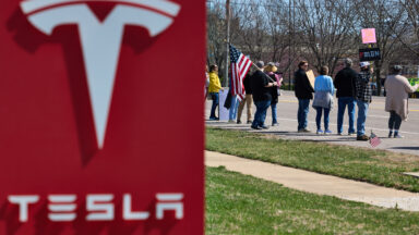 Protesters gather at the Tesla dealership in Chesterfield, Mo., on March 22, 2025.