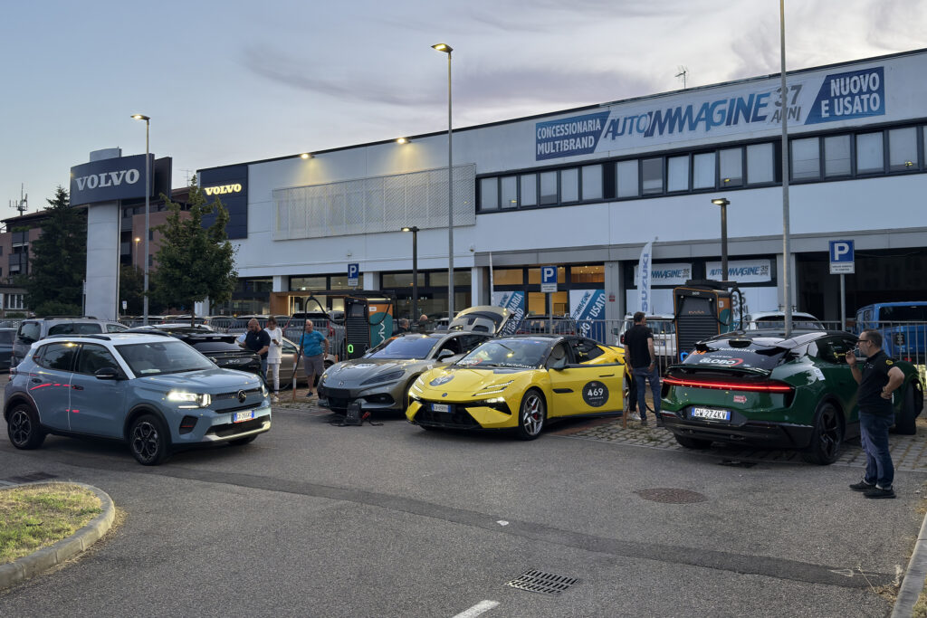 A collection of electric cars outside an Italian strip mall