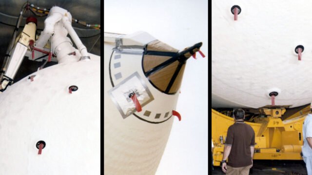 Bright red tags can be seen attached to a large component of space shuttle hardware.