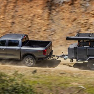 a 2025 Ford Ranger Lariat with FX4 Package towing a small camping trailer