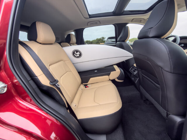 Mazda CX-5 back seat with a surfboard poking through the gap between the seats.