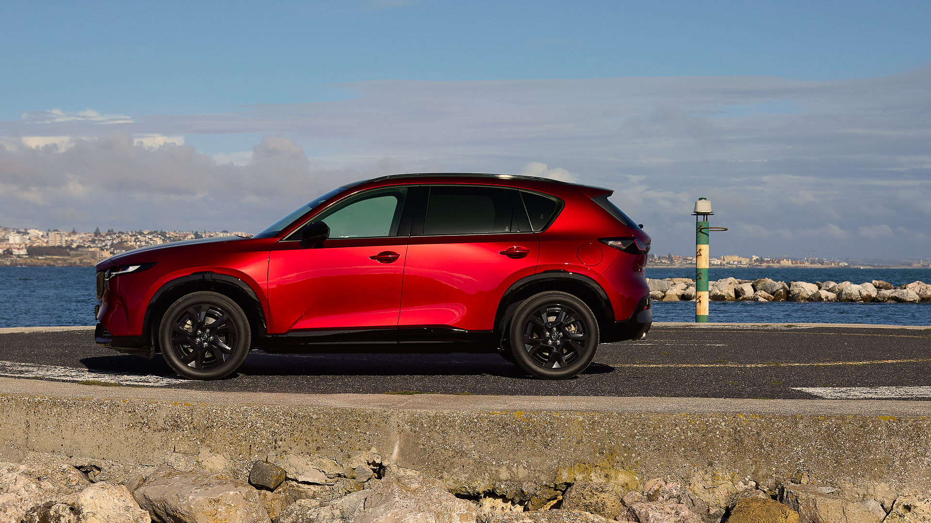 A red Mazda CX-5 in profile