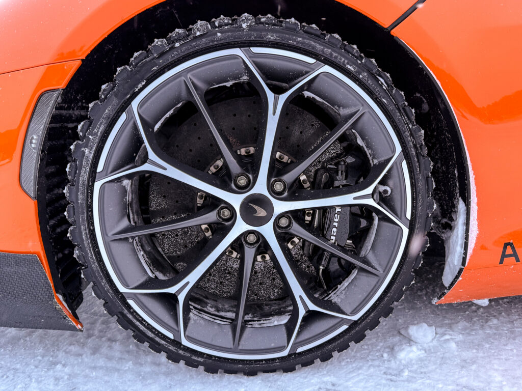 A McLaren Artura winter tire fitted with studs