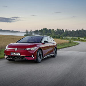 A red VW ID.7 drives towards the camera