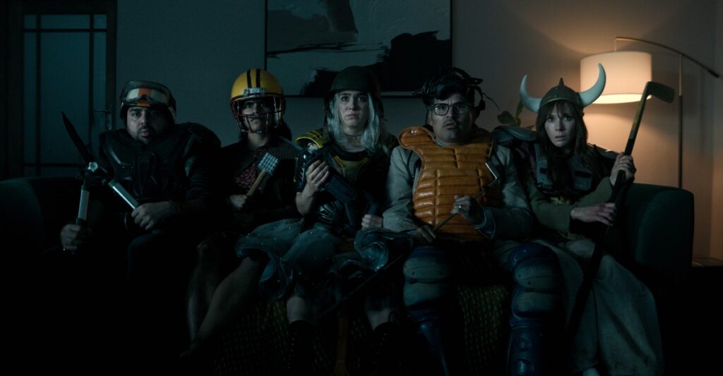 group of random looking people wearing makeshift armor and carrying found objects as weapons