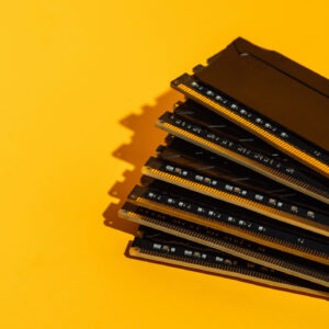 Fan arrangement of RAM sticks on yellow background.