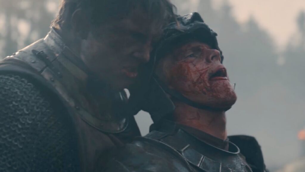 Closeup of victorious combatant holding the head of a blooded vanquished knight