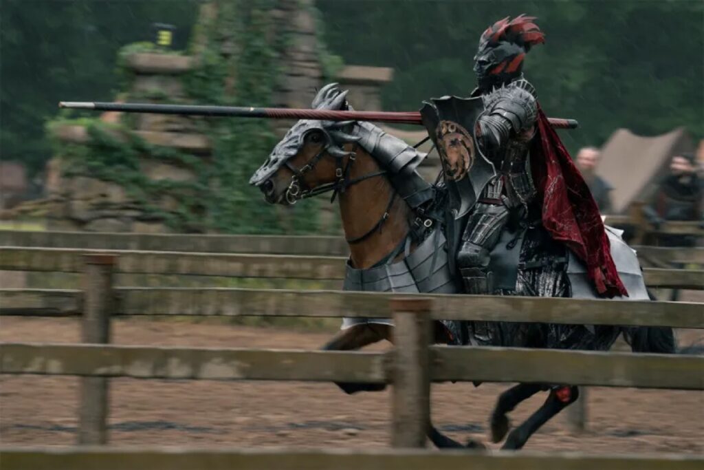 Fully armored knight on a horse in full charge during a joust