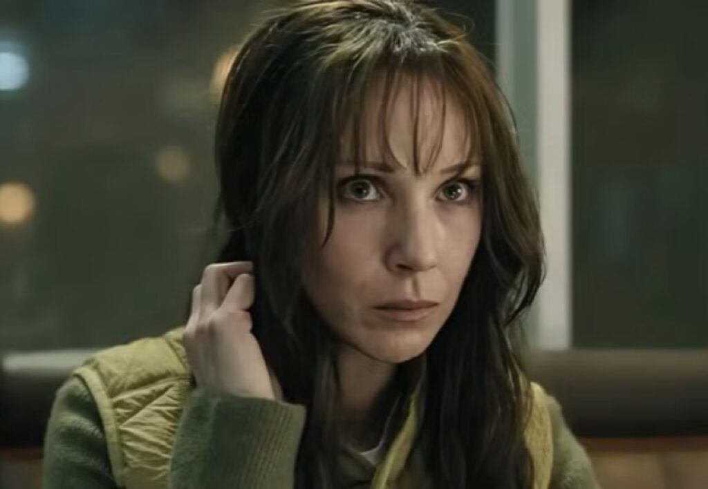 brunette woman wit long hair looking despondent
