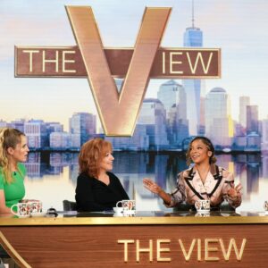 Five women sit at a table and talk during recording of an episode of The View.