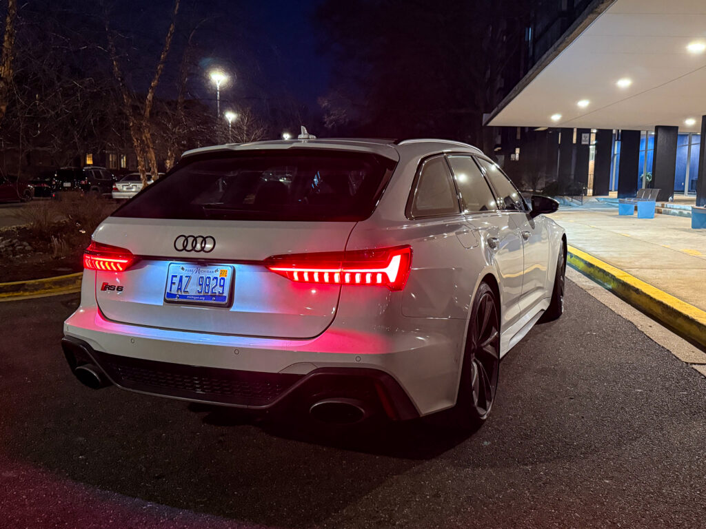 A white Audi RS6 from behind, at night