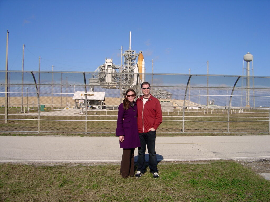 Photograph of two people standing near the LC-39A launch pad