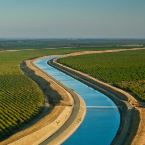 Aerial shot of farmland and aqueduct just off interstate 5 in Stanislaus County, California on a sunny afternoon in autumn.
