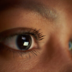 A close up of the upper portion of a person's face, showing both of their eyes.