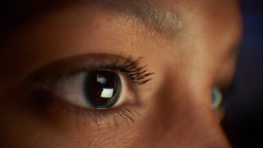 A close up of the upper portion of a person's face, showing both of their eyes.