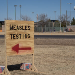 SEMINOLE, TEXAS - FEBRUARY 27: Signs point the way to measles testing in the parking lot of the Seminole Hospital District across from Wigwam Stadium on February 27, 2025 in Seminole, Texas. Eighty cases of measles have been reported in Gaines county with one death reported. (Photo by Jan Sonnenmair/Getty Images)