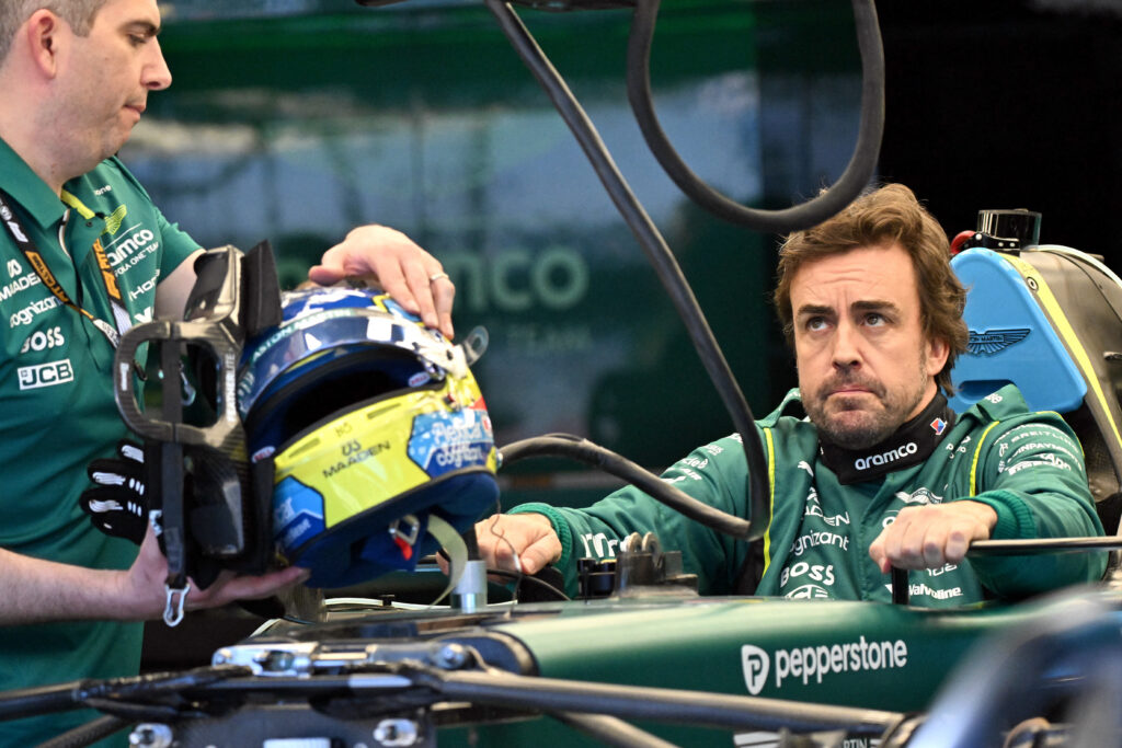 Aston Martin's Spanish driver Fernando Alonso inspects his car with team mechanics in the garage ahead of the Formula One Australian Grand Prix at Melbourne's Albert Park on March 5, 2026. (Photo by Paul Crock / AFP via Getty Images)