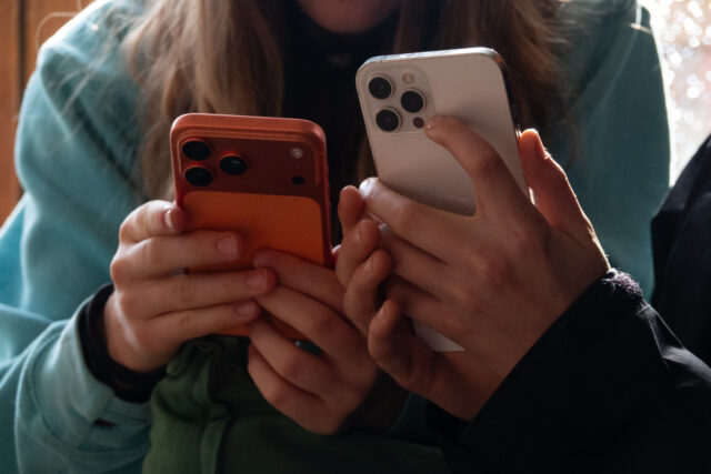 people holding iphones