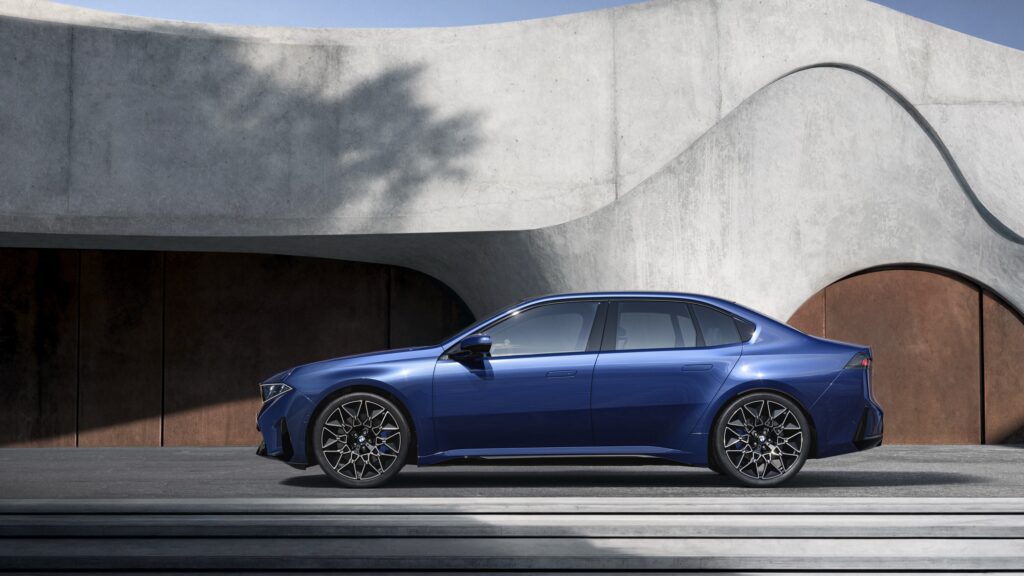 A blue BMW i3 sedan in profile