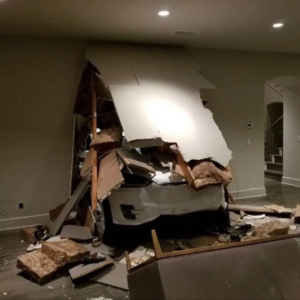 A Tesla model X after crashing through a garage wall into its house.