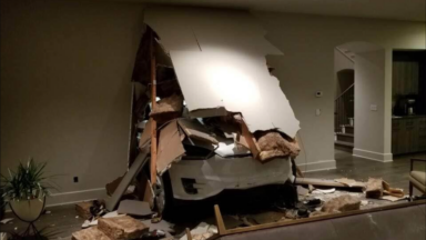 A Tesla model X after crashing through a garage wall into its house.