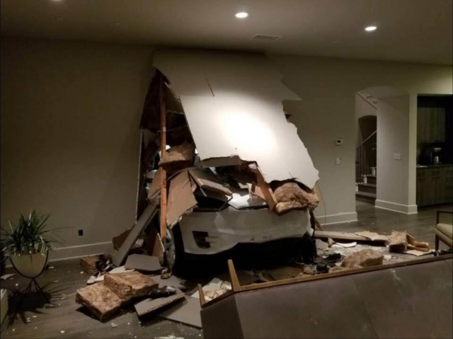 A Tesla model X after crashing through a garage wall into its house.