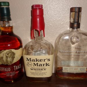 Different brands of Bottles of bourbon: Buffalo Trace (left), Maker's Mark (center), and Woodford Reserve (right)