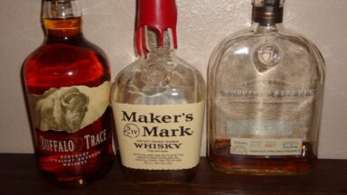 Different brands of Bottles of bourbon: Buffalo Trace (left), Maker's Mark (center), and Woodford Reserve (right)