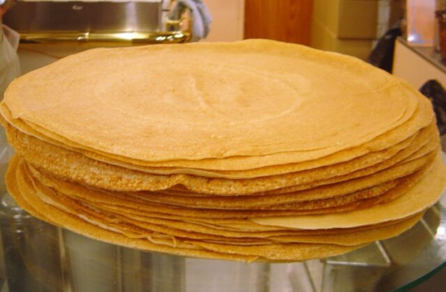 closeup of a stack of thin golden crepes