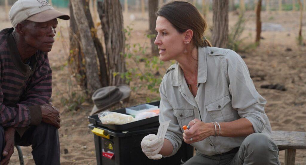 Xui receives instructions on collecting DNA samples from Dr. Jordana Meyer of Stanford University.