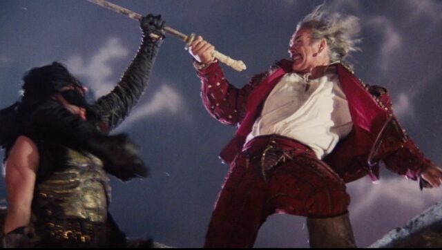 two swordsmen dueling on a Scottish rampart, with the left man in black gaining the other hand