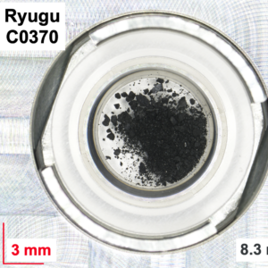 Image of two dishes, both containing a dark powdery material with larger chunks in it.