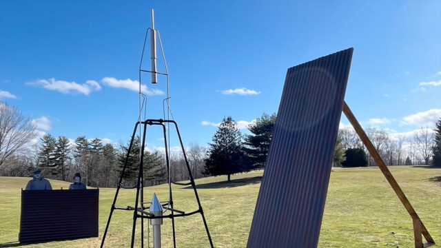 a photo of a replica of an early rocket on display on a golf course