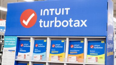 A large display inside a store holds numerous versions of the Intuit TurboTax tax-preparation software.