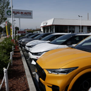 WEST COVINA, CALIFORNIA - MARCH 30: Used electric vehicles are displayed on the sales lot at Plug-In Auto on March 30, 2026, in West Covina, California. As gas prices surge amid the war in Iran, online automotive resource Edmunds reported a 22% increase in searches for electric vehicles during the week of March 2, as motorists look for ways to avoid high fuel costs. (Photo by Justin Sullivan/Getty Images)