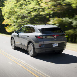 A grey ID.4 drives away from the camera