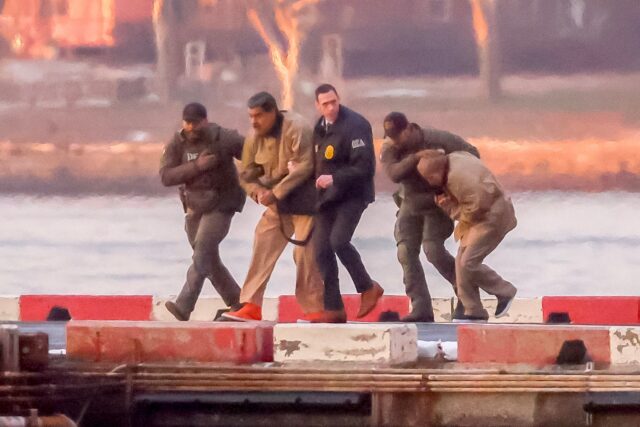 Ousted Venezuelan President Nicolas Maduro being escorted by US law enforcement officials.