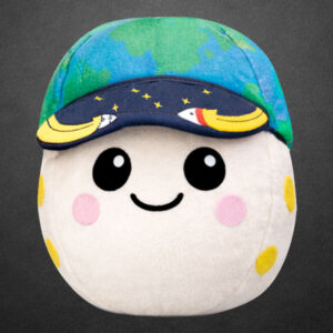a plush moon with pink and yellow craters, two eyes and a smile, wearing a blue and green cap