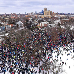 An aerial photo taken by a drone from above shows wintry scene with a large crowd of people gathered in Powderhorn Park in Minneapolis on January 10, 2026 to protest the killing of Renee Good by an ICE agent.
