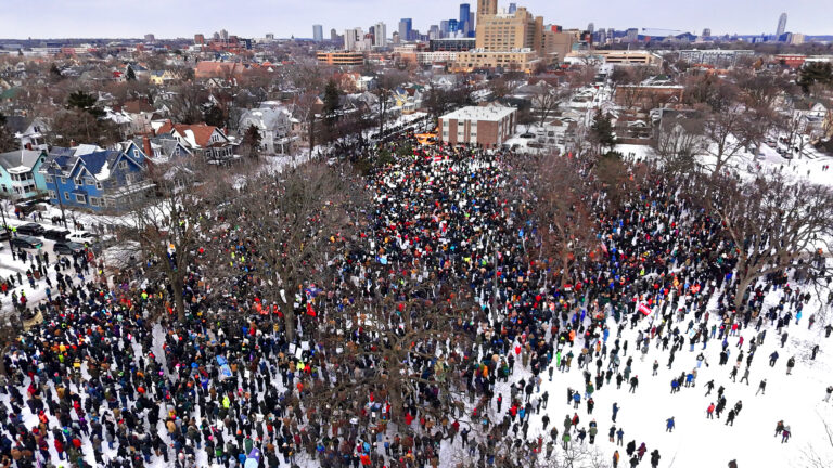 An aerial photo taken by a drone from above shows wintry scene with a large crowd of people gathered in Powderhorn Park in Minneapolis on January 10, 2026 to protest the killing of Renee Good by an ICE agent.