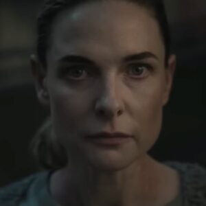 close up of woman with hair pulled back in a ponytail looking resolved