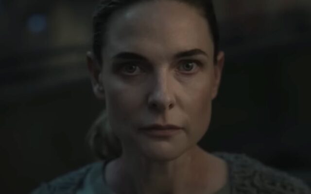 close up of woman with hair pulled back in a ponytail looking resolved