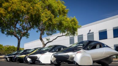 Five Aptera EVs parked in a row.
