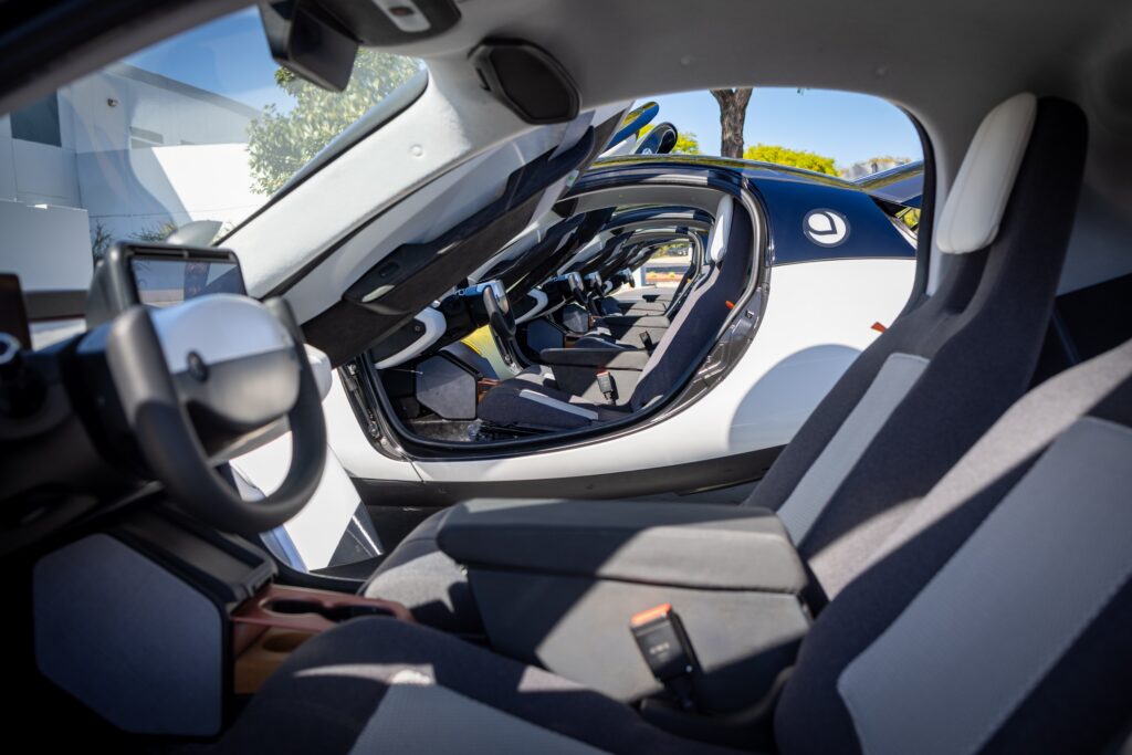 A look through the open doors of several Aptera EVs.