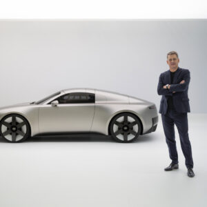 A man stands next to a car