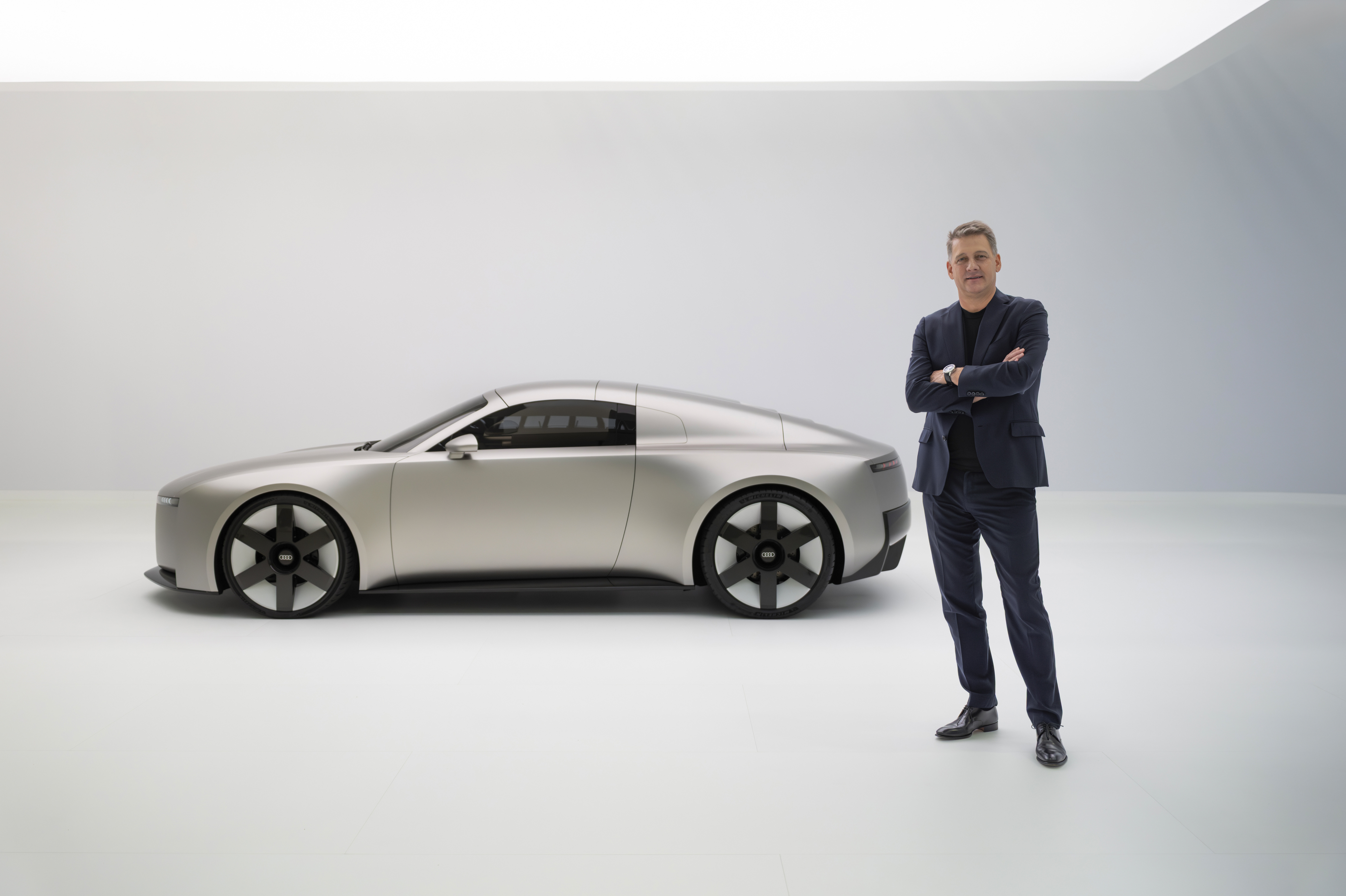 A man stands next to a car
