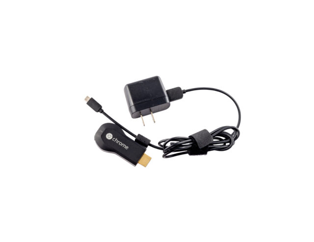 1st generation Chromecast HDMI dongle isolated on white background.